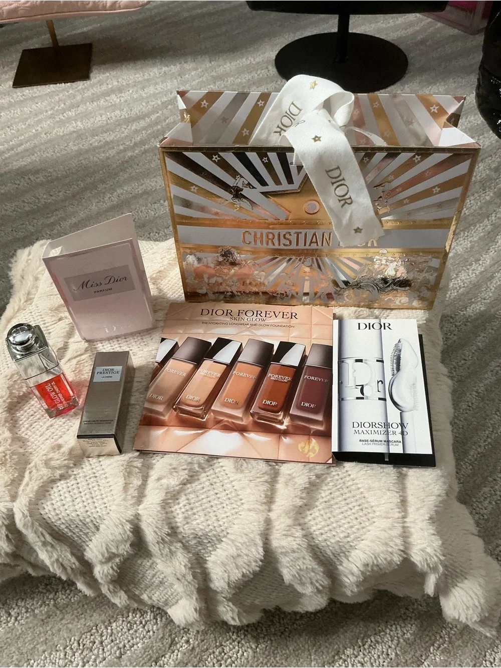 Dior gift package with gold & white festive bag and neutral samples
